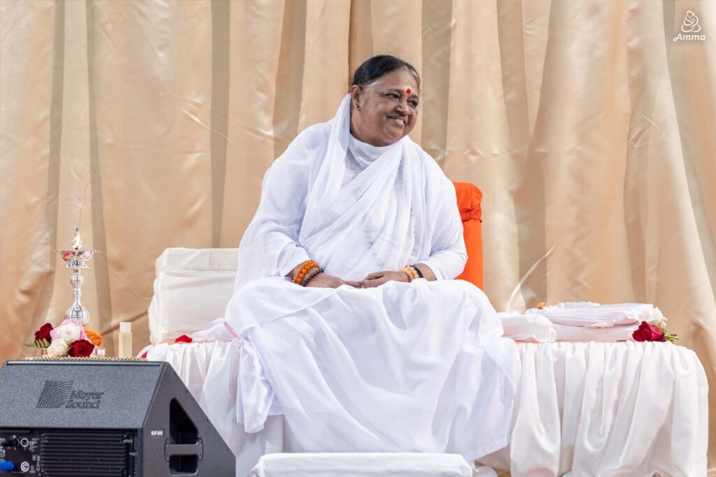 Amma smiles at the people from the stage