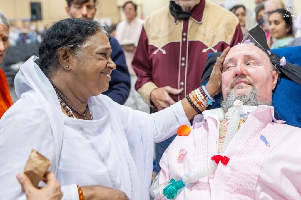 Amma with a disabled man