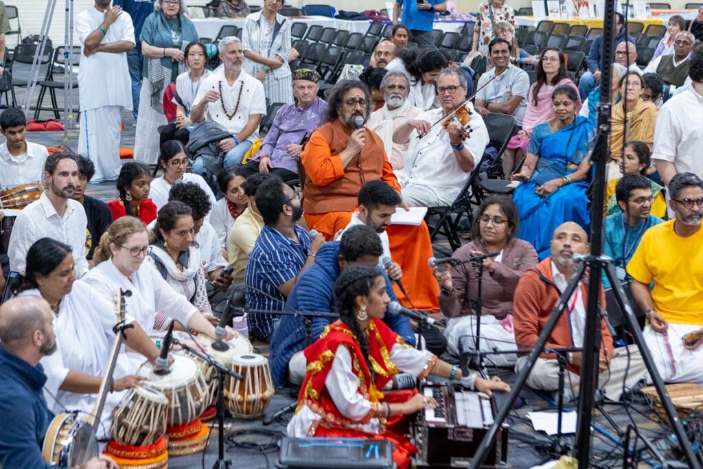 A Swami sings with musicians