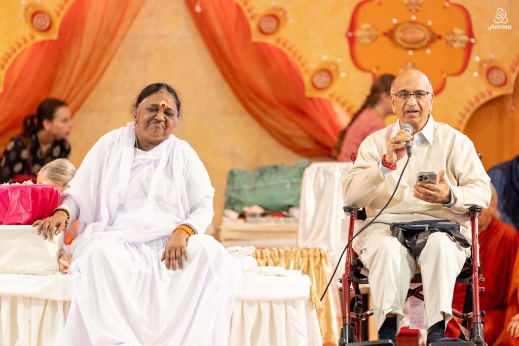 Amma with a man with a microphone