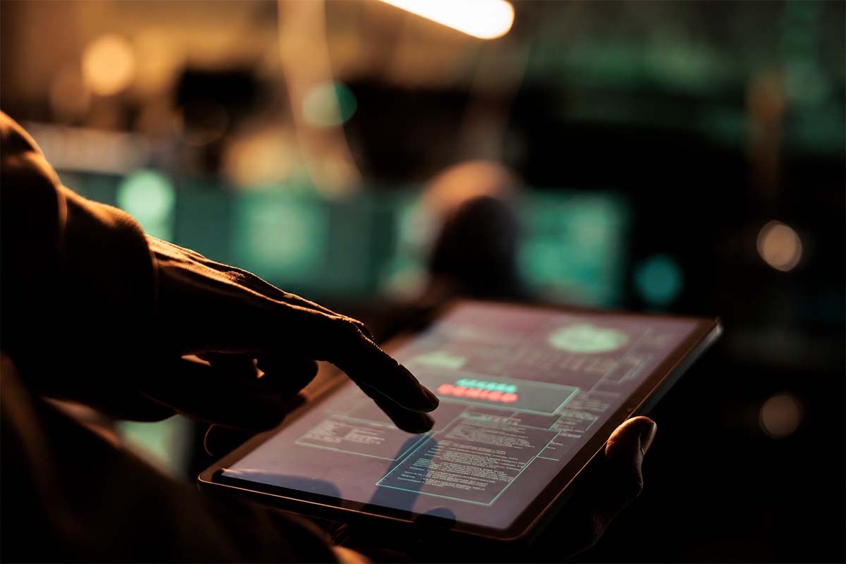 a hand touches a tablet