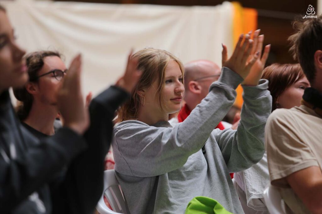 a crowd of young people clap