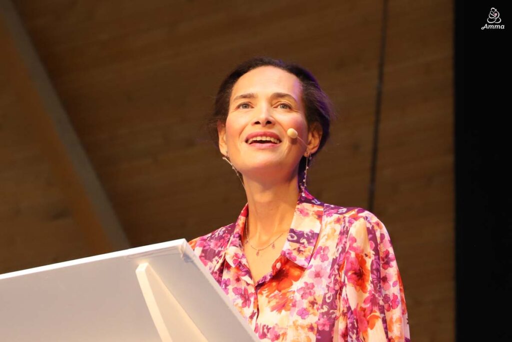 a woman speaks at a microphone