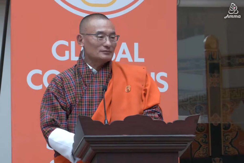 a man speaks at the microphone