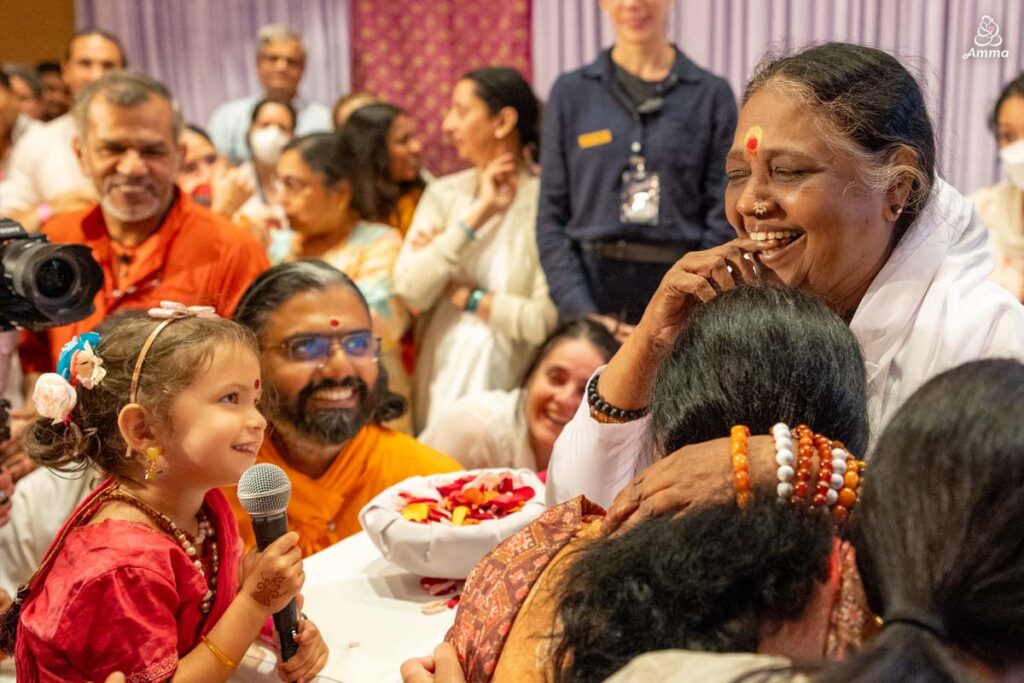 Amma and a little girl laugh