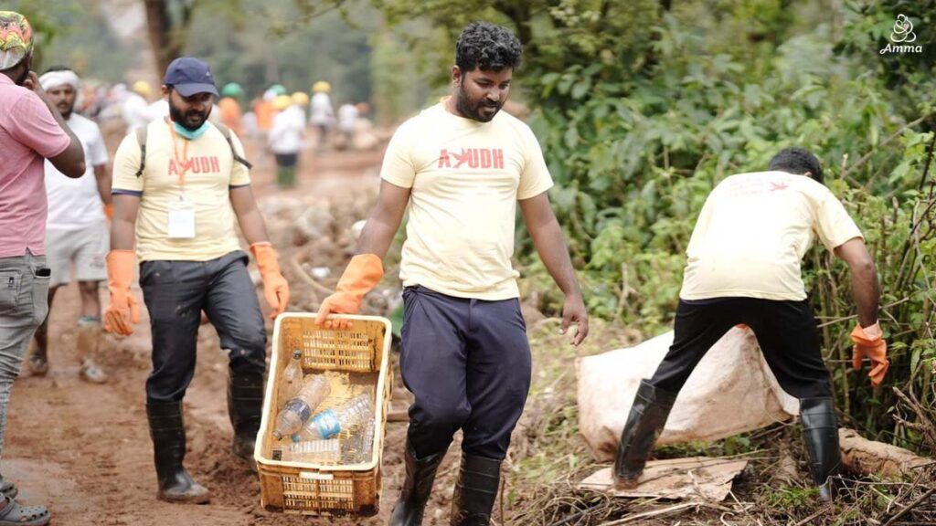 men carrying plastic waste on a forest road