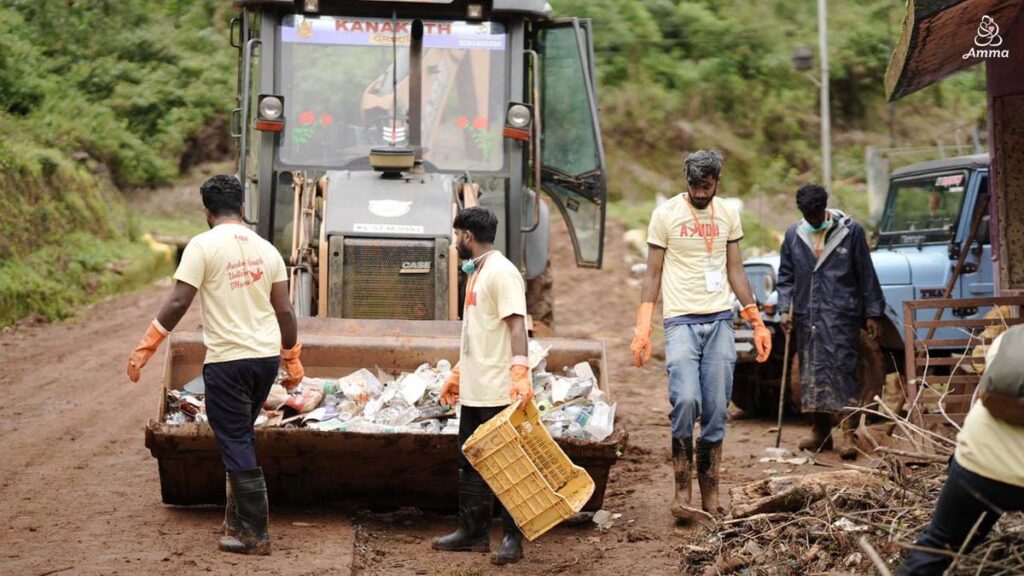 men pick up trash with a bulldozer