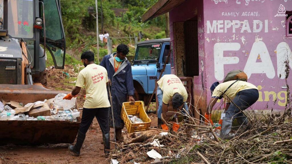 Men pick up debris from the landslide