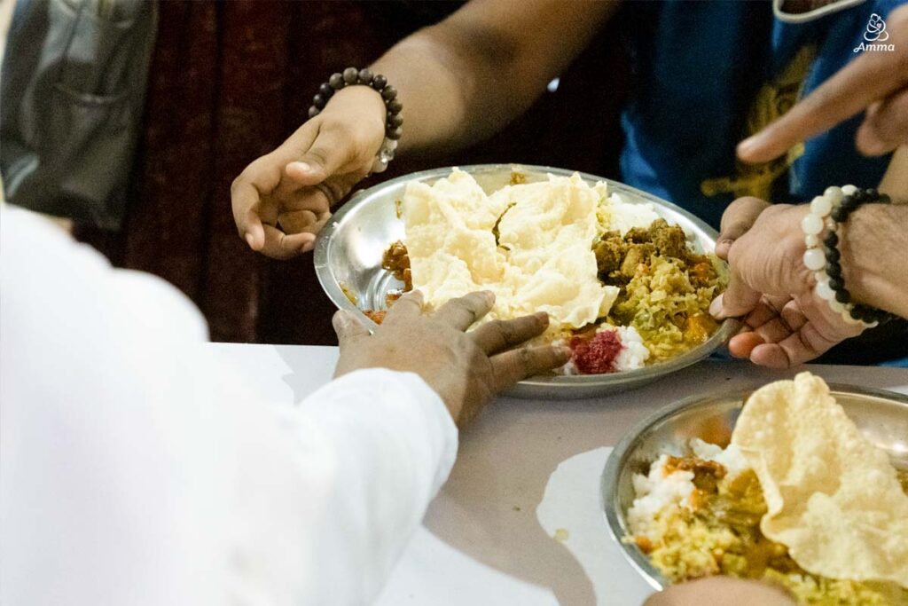 Amma's hand gives prasad