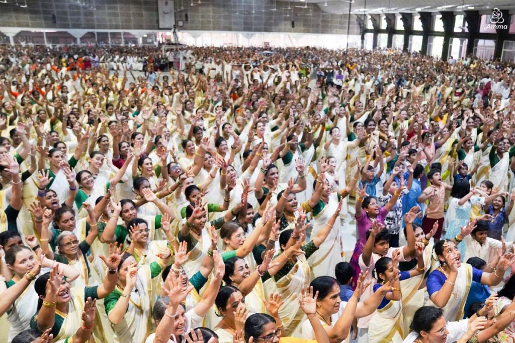 A long shot of people raising their arms in cheers