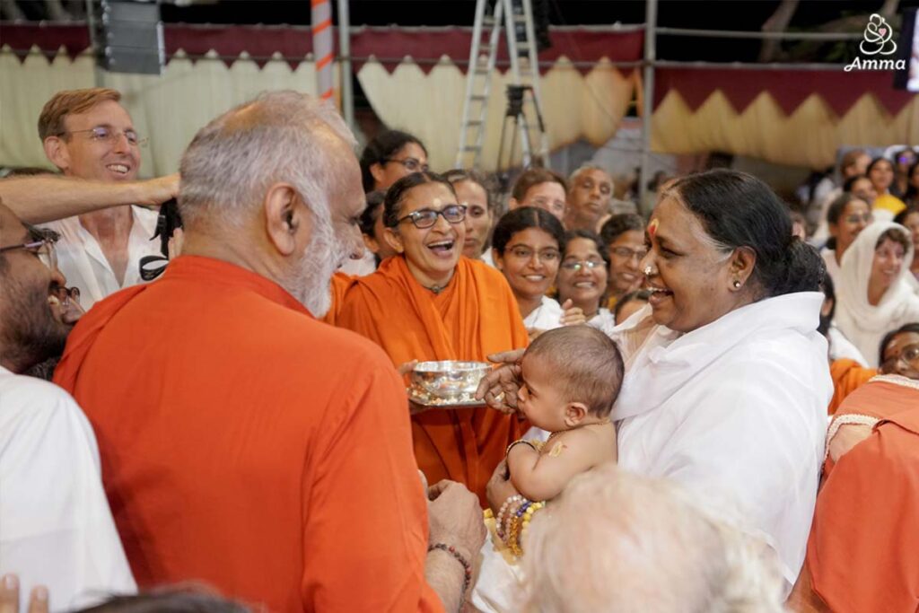 Amma feeds a baby