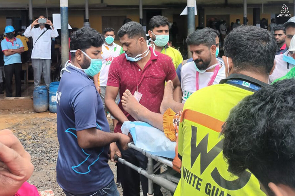 A team transports a patient to an ambulance