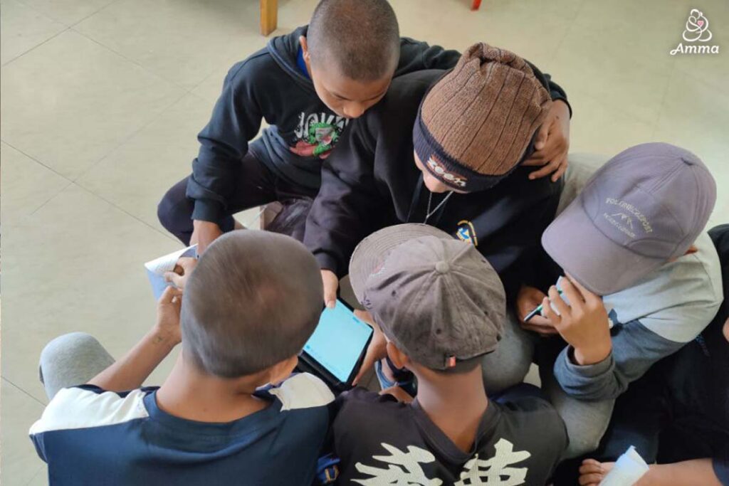 a group of adolescent boys with a tablet