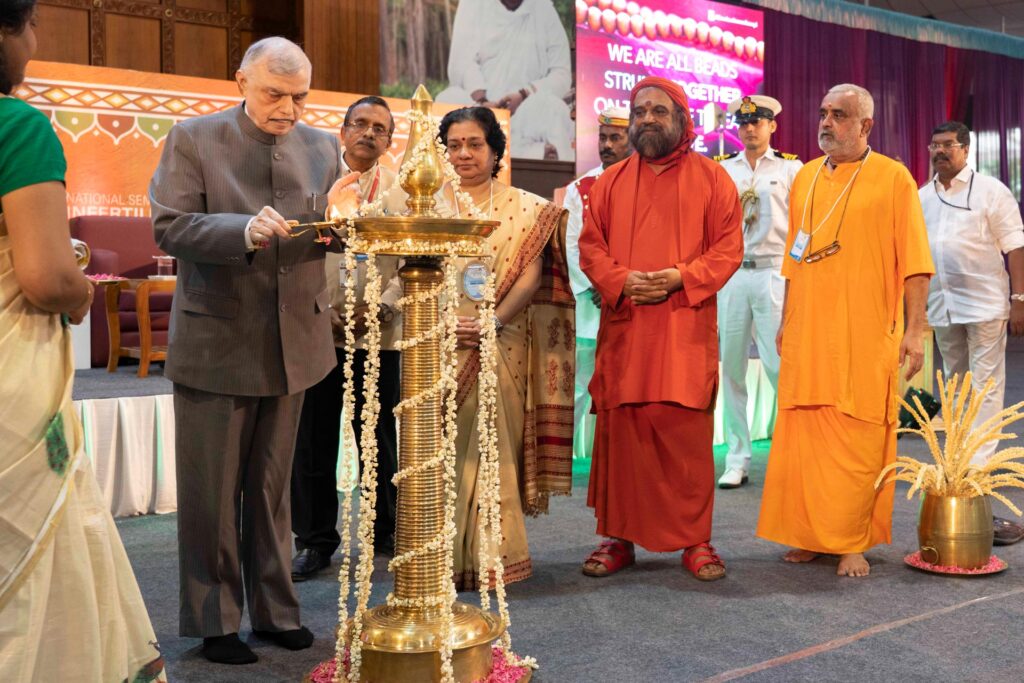 Hon. Kerala Governor (Retd.) Justice P. Sadasivam lights the inagural lamp which stands approx. 4 feet high, while Swami Poornamrtananda Puri and Br. Sankara Chaitanya and other dignitaries look on.