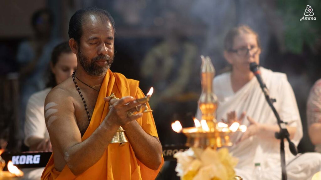 A pujari waves a flame