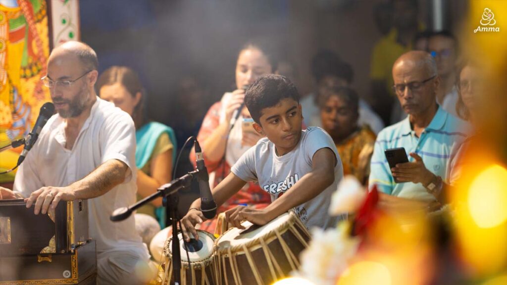 a boy plays tabla