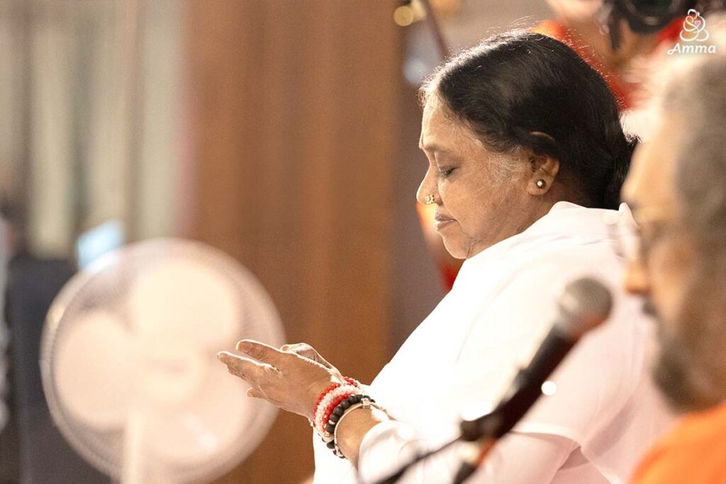 Amma looks at her hand