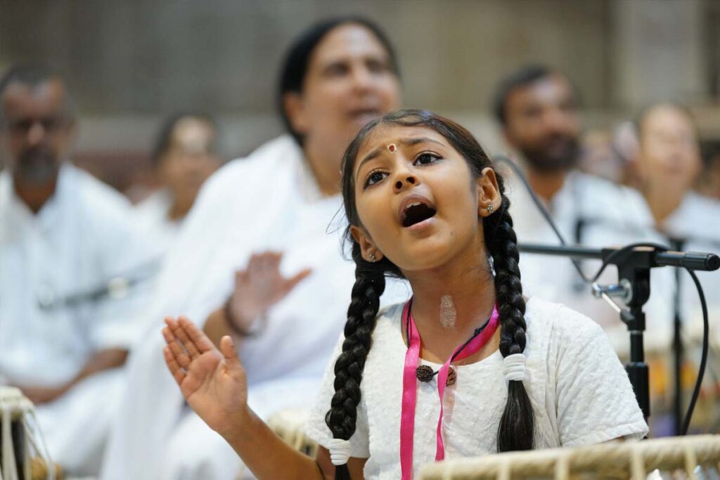 One of the Ashram children sings from her heart