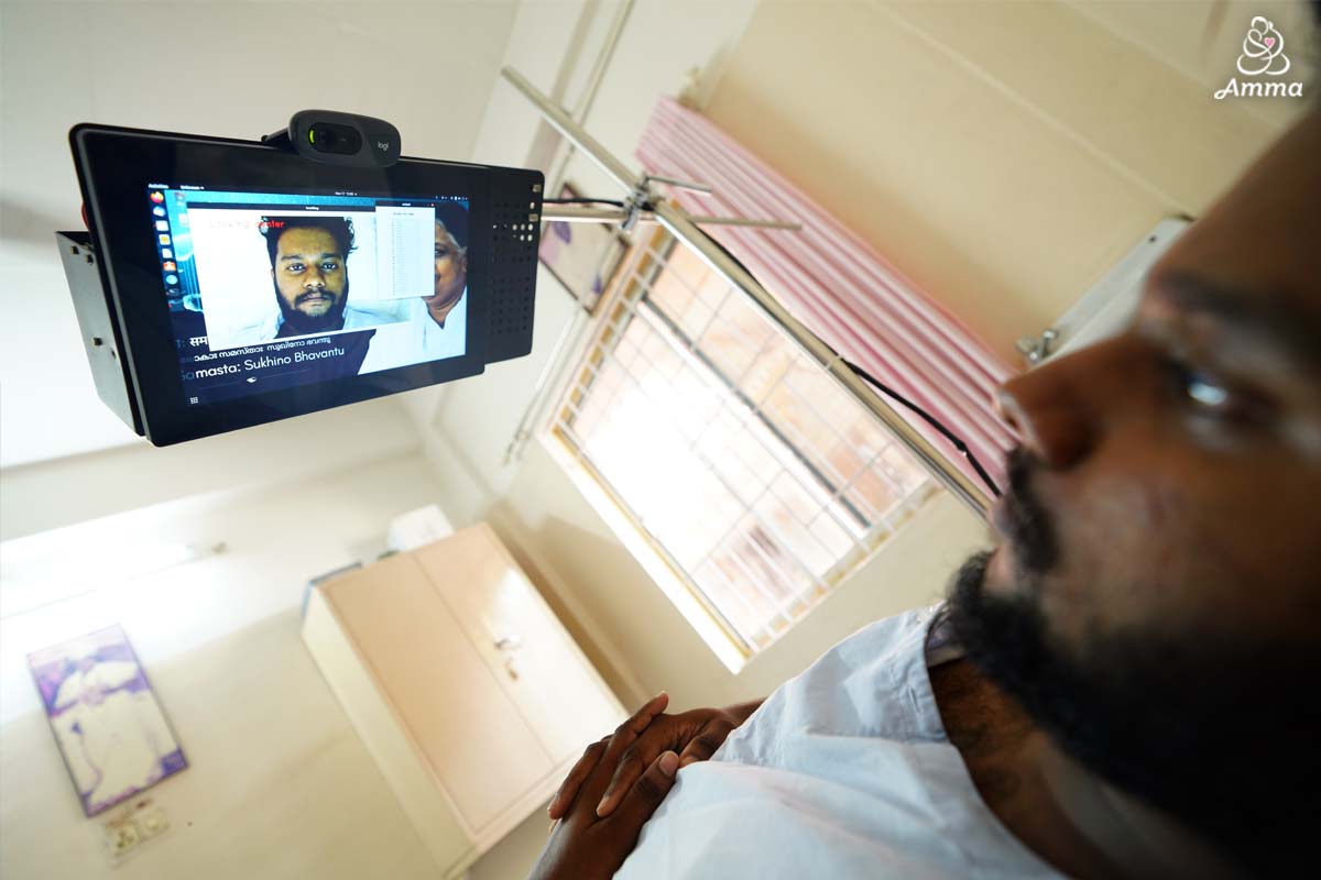a man looks up at a tablet device above him