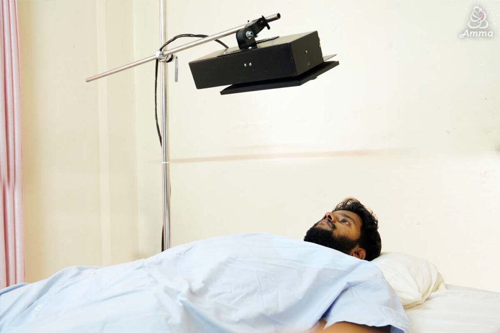 a man in a bed looks at a tablet above