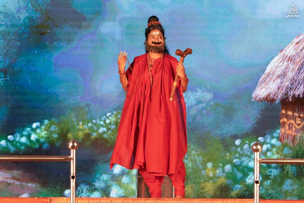 A Swamini plays the role of a sannyasi with a beard and moustache