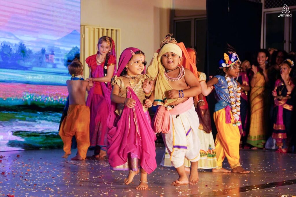 A small girl and boy dance