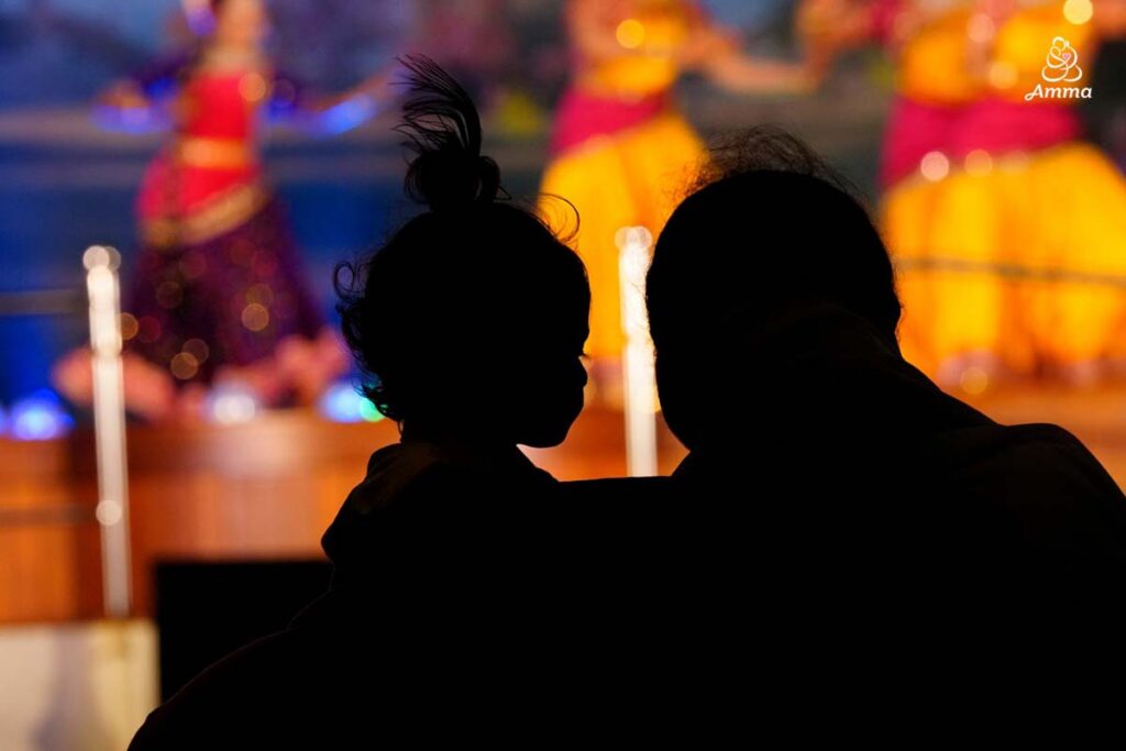 silhouette of Amma with a child