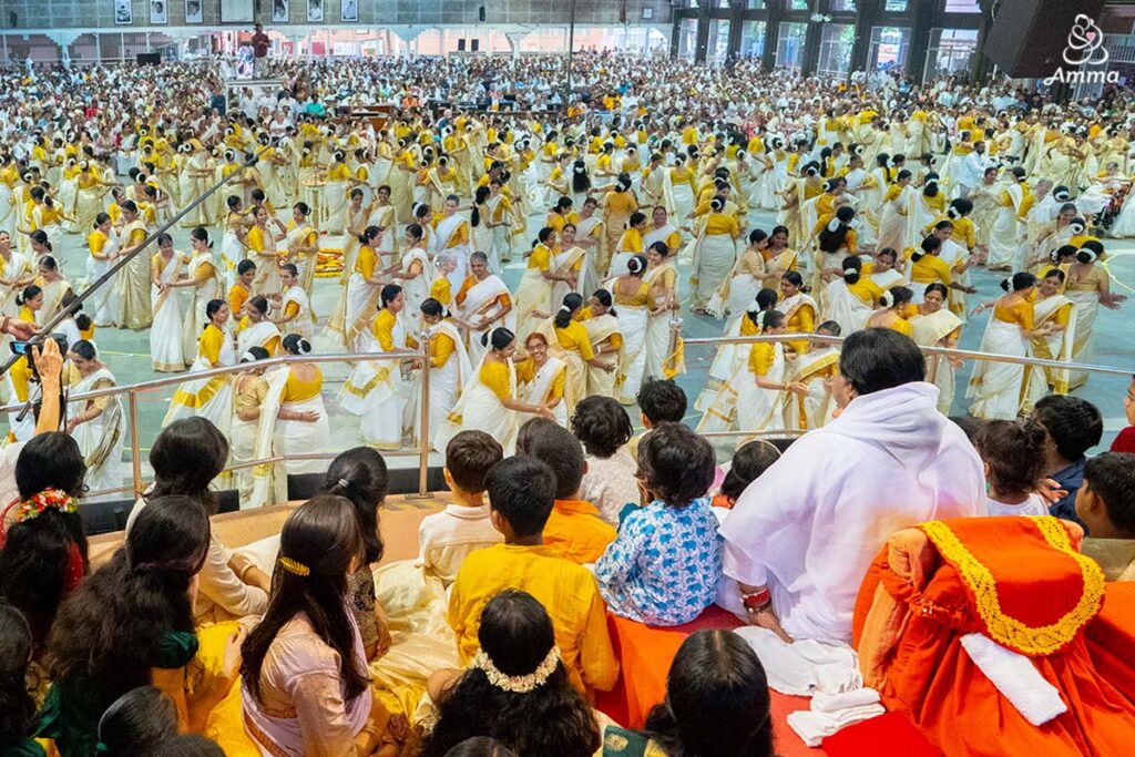 Amma watches a traditional dance performance