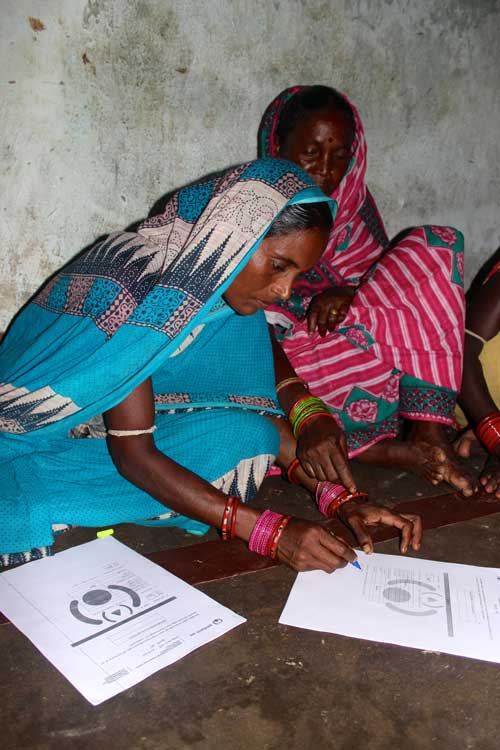 Village women signing papers