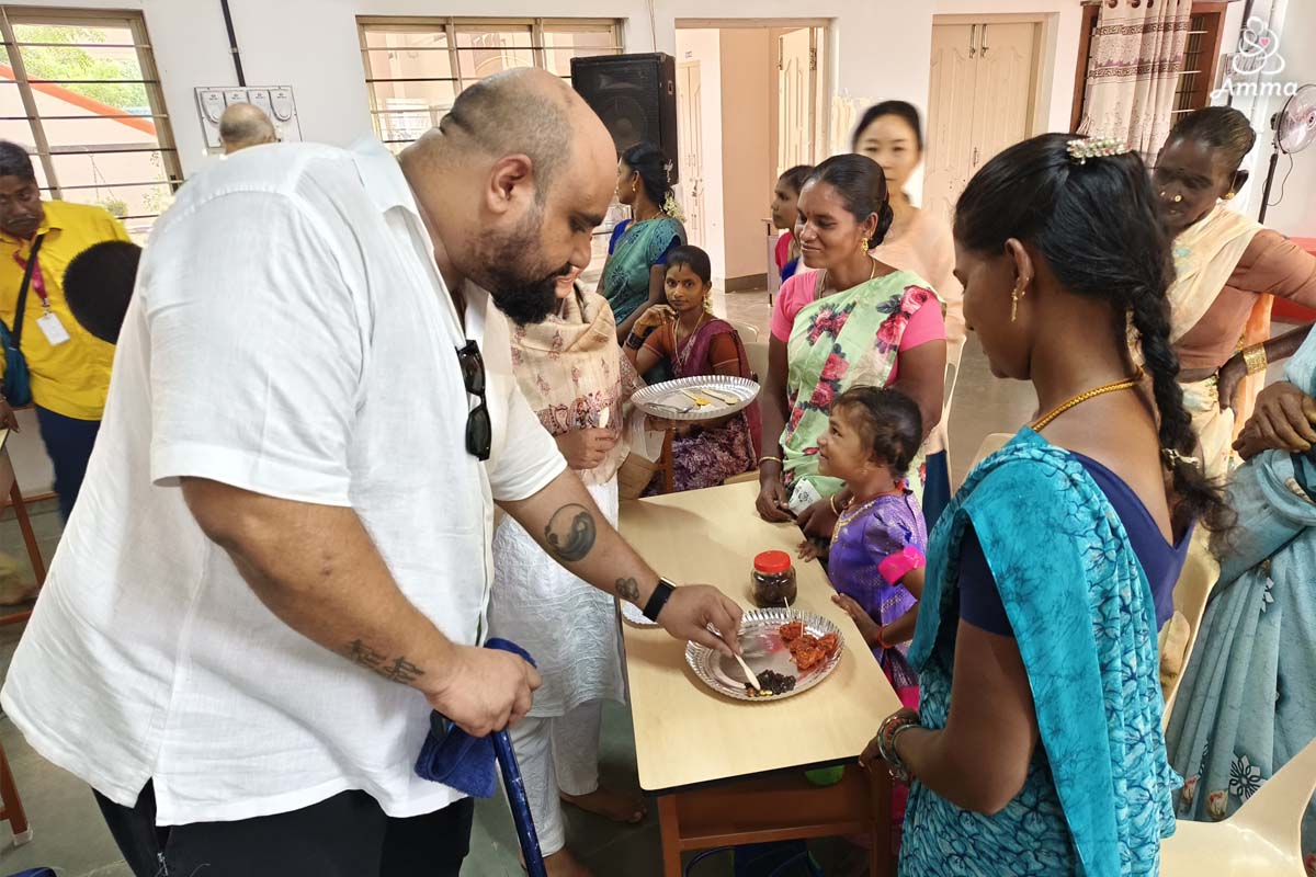a man tastes some creative food made by a women's self-help group
