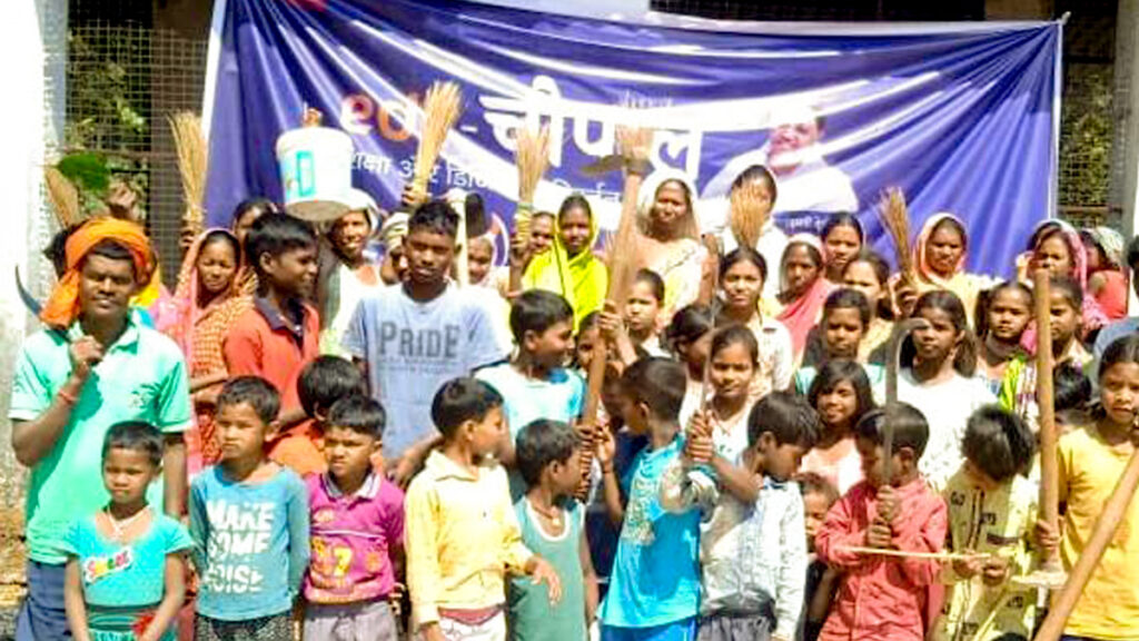 Children with their cleaning brooms in Jharkhand