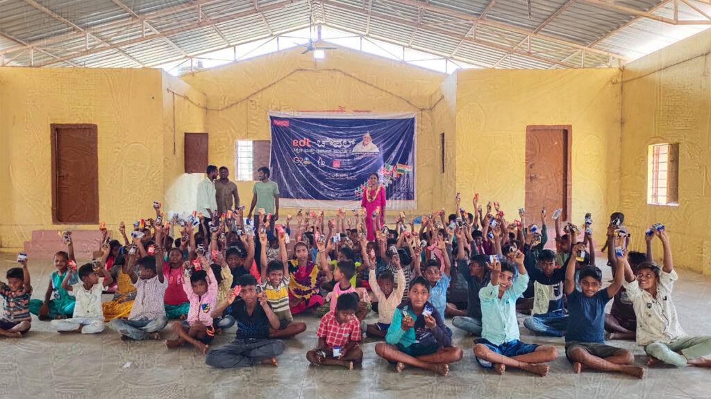 A school of children raise their arms in Karnataka