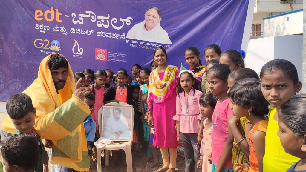 A group of children near Amma's photo in Karnataka