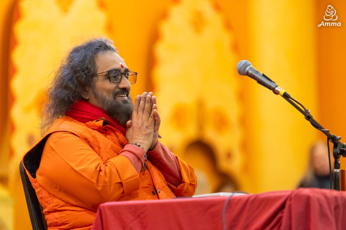 A Swami smiles with folded hands
