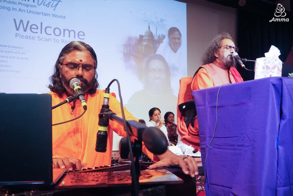 A brahmachari and a swami lead bhajans