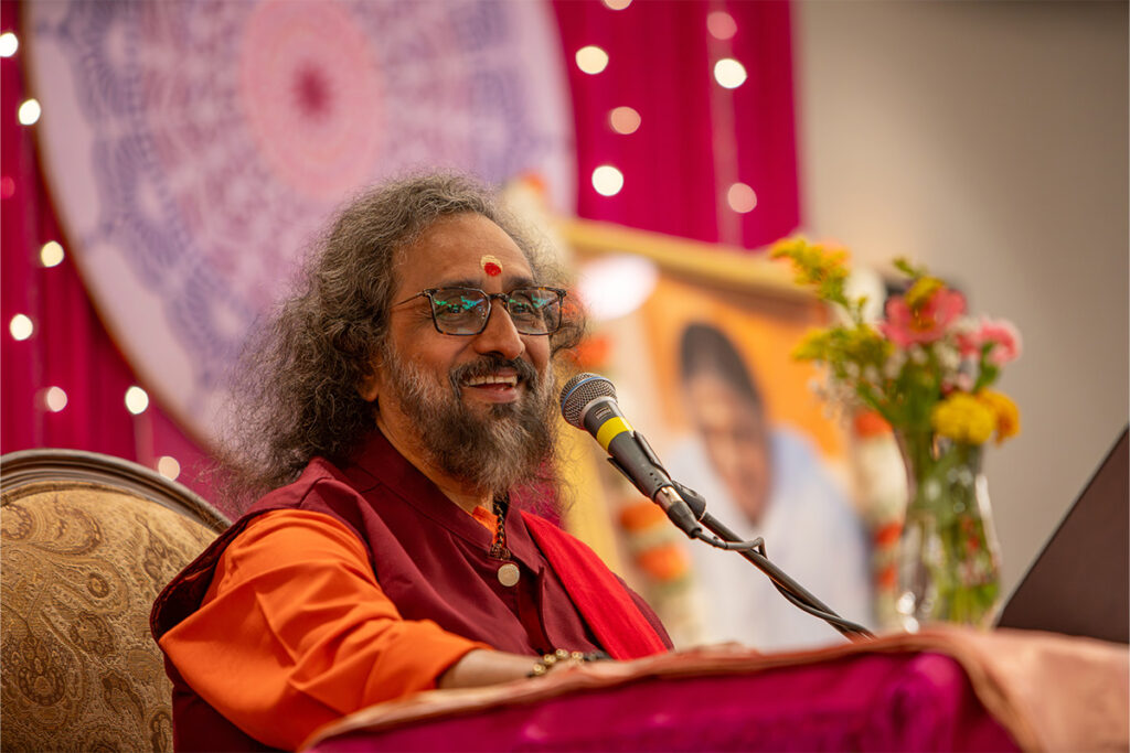 a swami at a microphone