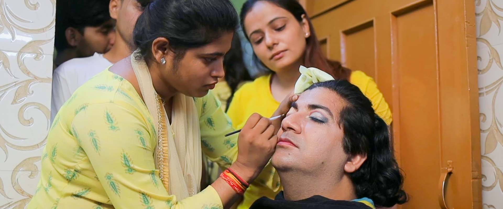 a beautician applies makeup to a client