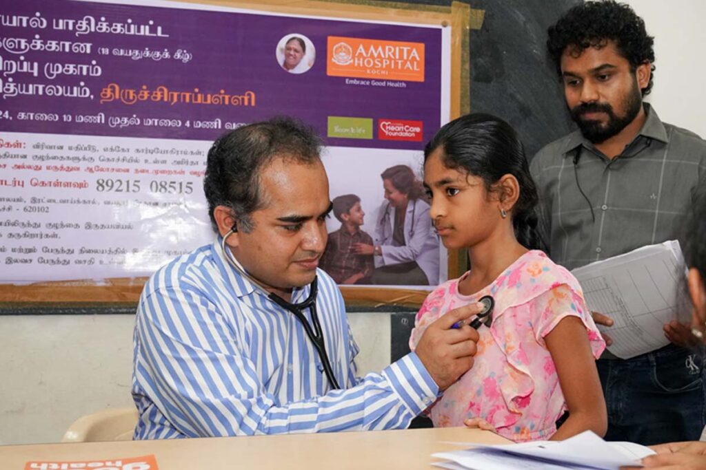 Doctor measures a young girl's heartbeat
