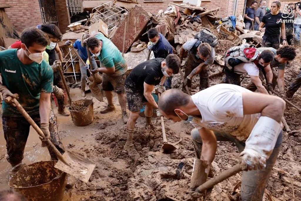 cleaning up a muddy street with shovels