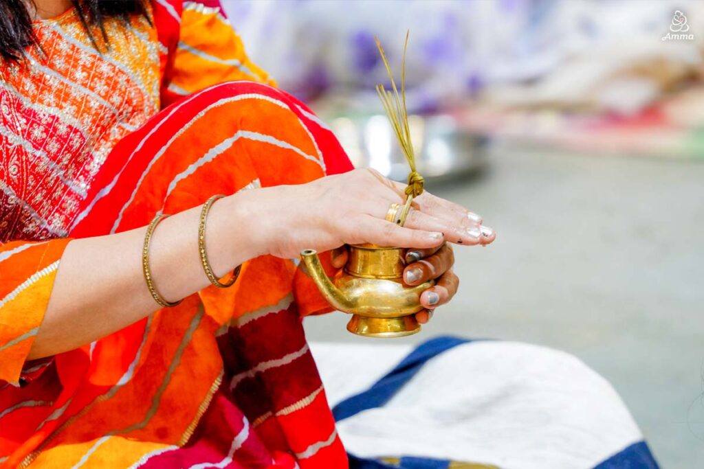 A woman's hand covers a brass cup