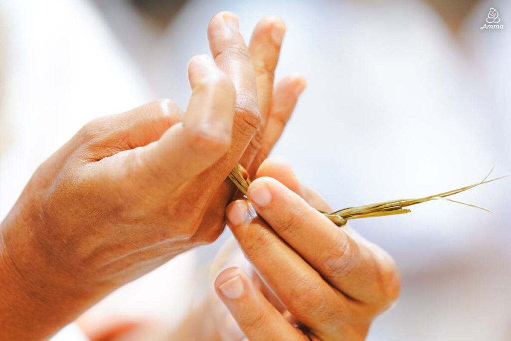 Placing a ring made of grass on a finger