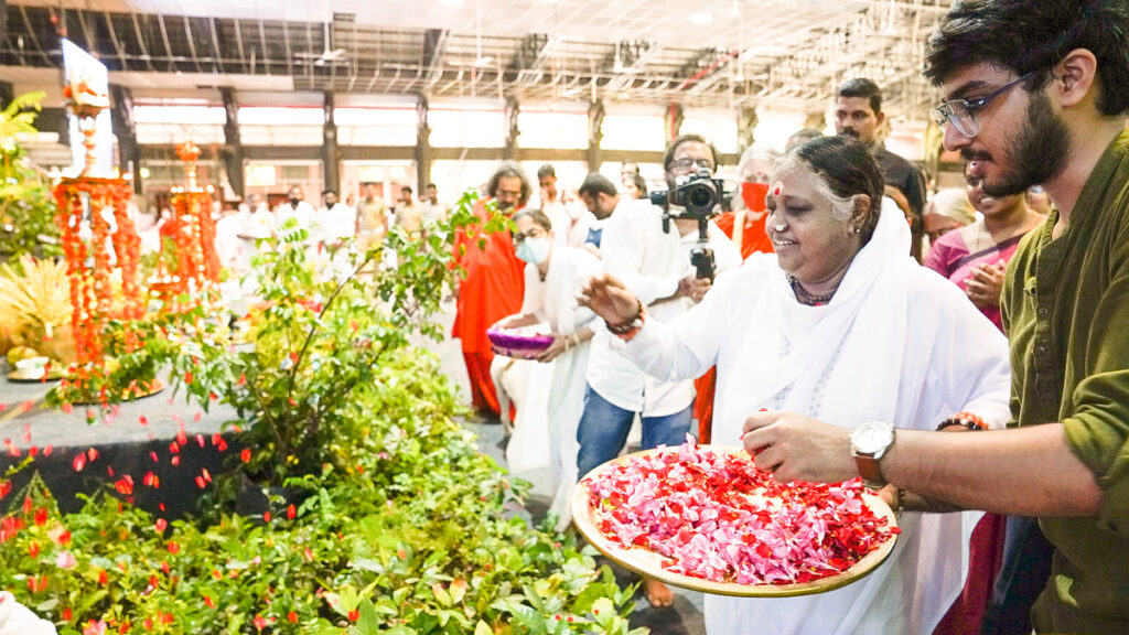 Amma blesses the saplings for AYUDH to plant.