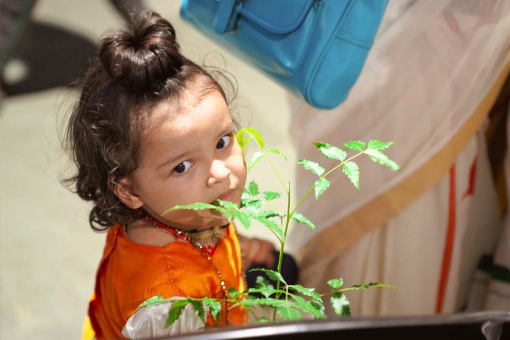 Small girl with saplings