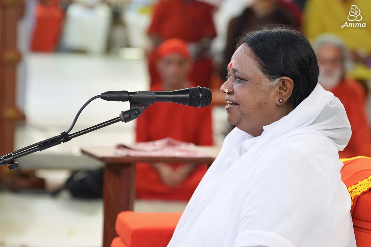 A photo of Amma at a microphone