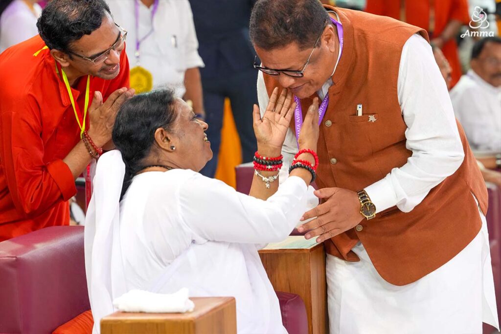 Amma looks up at a man