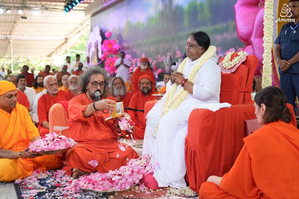 Disciples perform pada puja to Amma as Guru