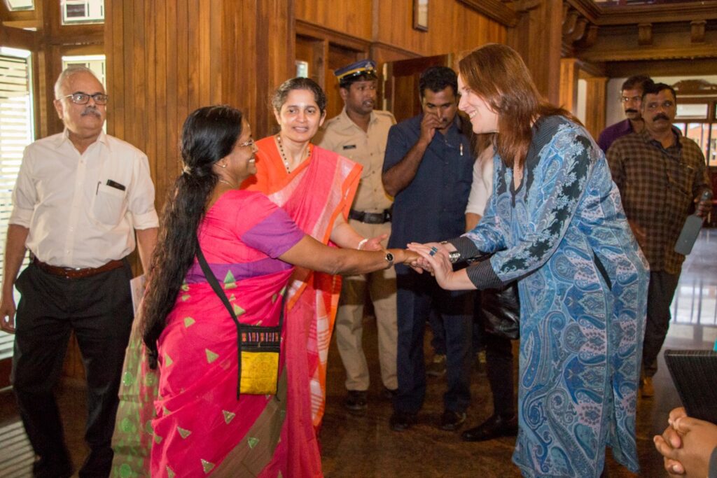 Dana Kursch shakes hand with Indian woman