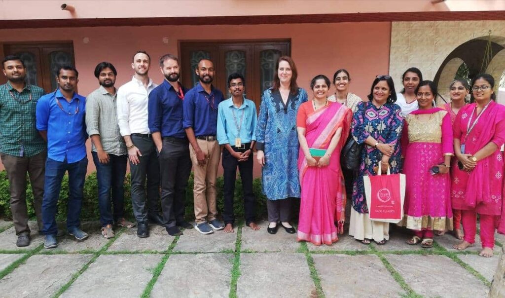 The AMMACHI labs team poses for a photo with Dana Kursh