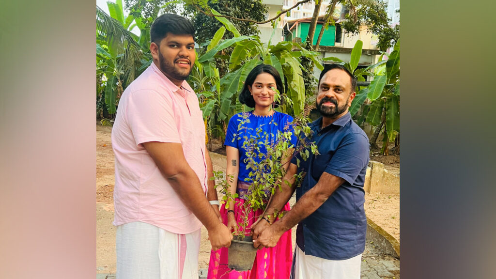 Holding a tulsi plant