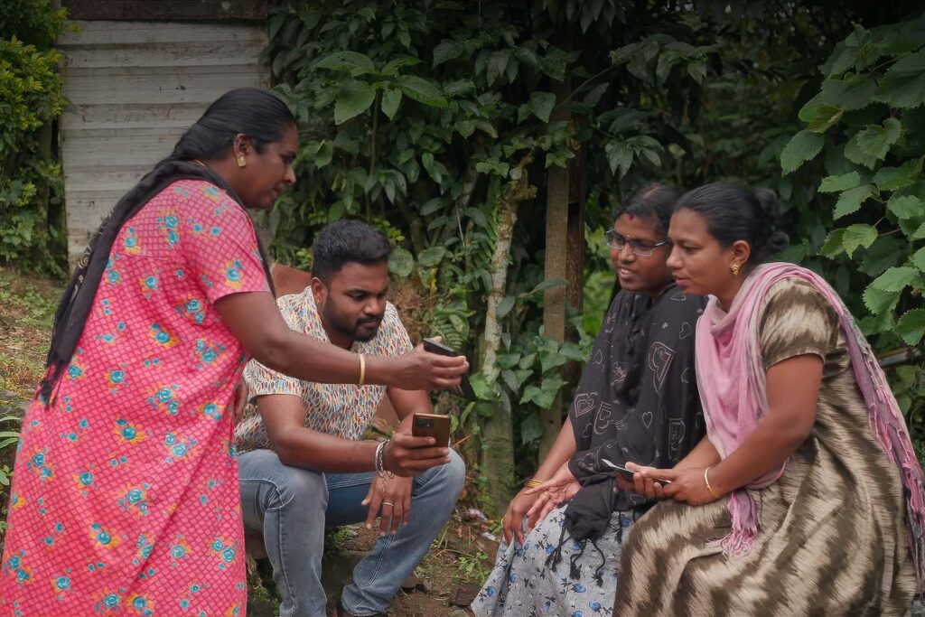 two scientists speak two two women demonstrating with mobile phones